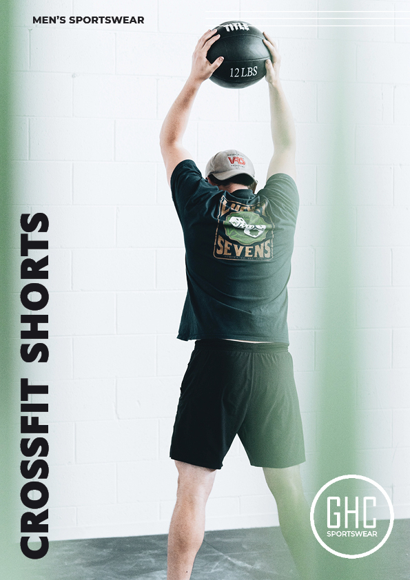 Man wearing custom men's CrossFit shorts from GHC Sportswear, performing an overhead medicine ball exercise. Perfect for high-intensity workouts and personalized to fit.