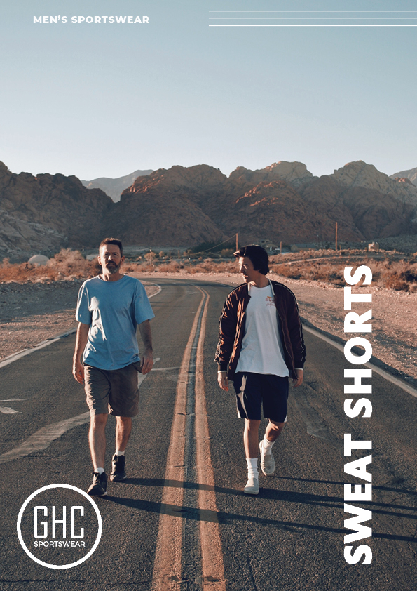 Two men walking on a deserted road with mountains in the background, both wearing GHC Sportswear custom men's sports shorts, showcasing the customizable options for men's sportswear.