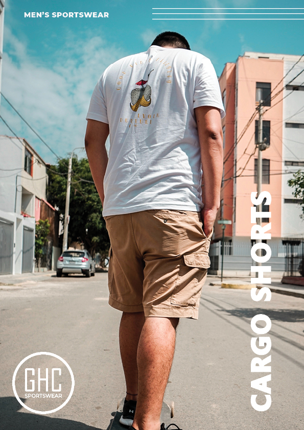 A man wearing custom men's cargo shorts from GHC Sportswear, walking on a sunny street. The image highlights the shorts' style and functionality, perfect for casual wear and outdoor activities. The shorts feature multiple pockets and a comfortable fit, ideal for personalized customization.