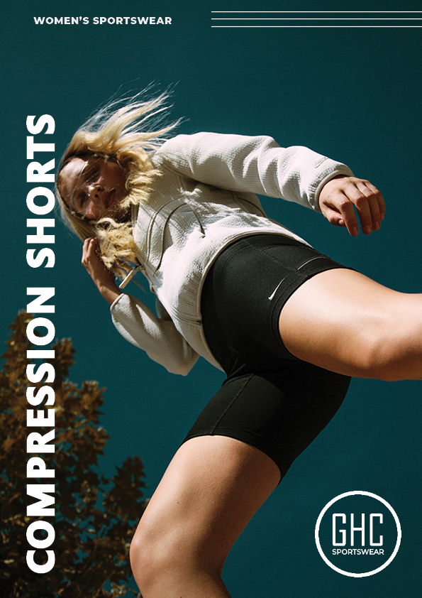 A woman in athletic wear, featuring custom women's compression shorts from GHC Sportswear, jumping outdoors against a blue sky backdrop. The image emphasizes the shorts' snug fit and performance benefits.