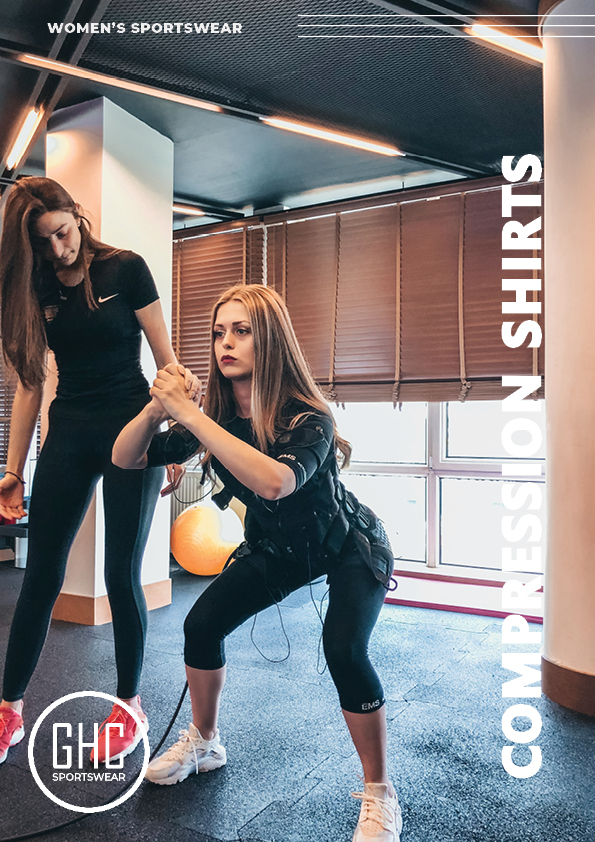 Two women working out in a gym, one wearing a custom women's compression shirt from GHC Sportswear. The image highlights the shirt's snug fit and performance-enhancing design, emphasizing its customizability for a perfect workout experience.