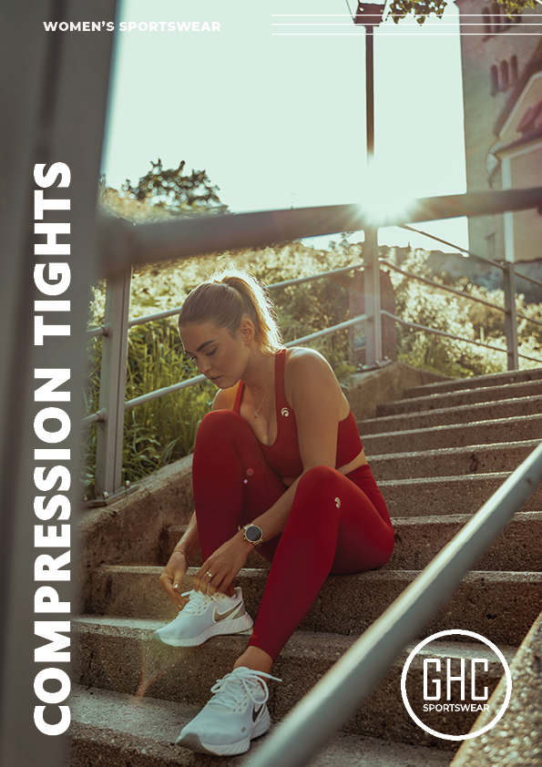 Woman sitting on outdoor stairs, adjusting her shoes, wearing red custom women's compression tights from GHC Sportswear, with a backdrop of greenery and sunlight.