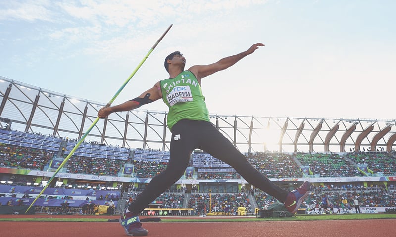 arshad nadeem olympic record: the javelin throw that made history 14 Arshad Nadeem Olympic record inspired javelin throw athlete in stadium competition sportswear.