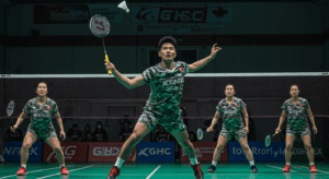 Badminton players in camouflage-patterned uniforms on an indoor court