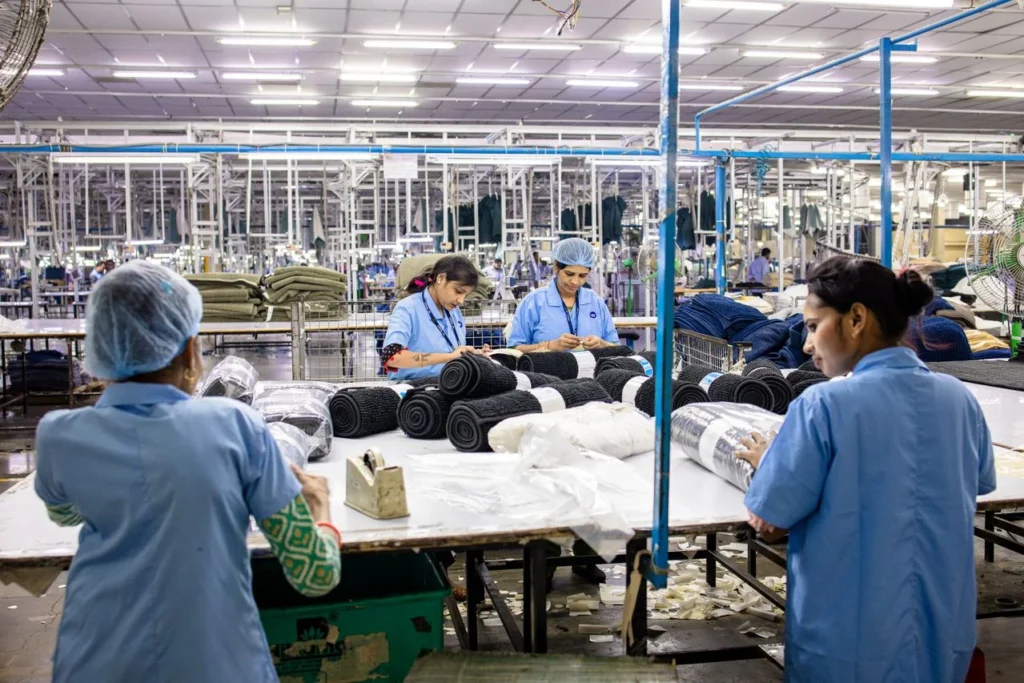 custom sportswear manufacturer inspecting fabrics for activewear production