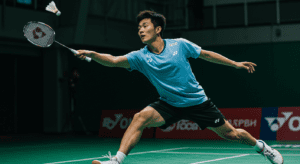 Badminton player wearing a breathable shirt, lightweight shorts, and non-marking shoes