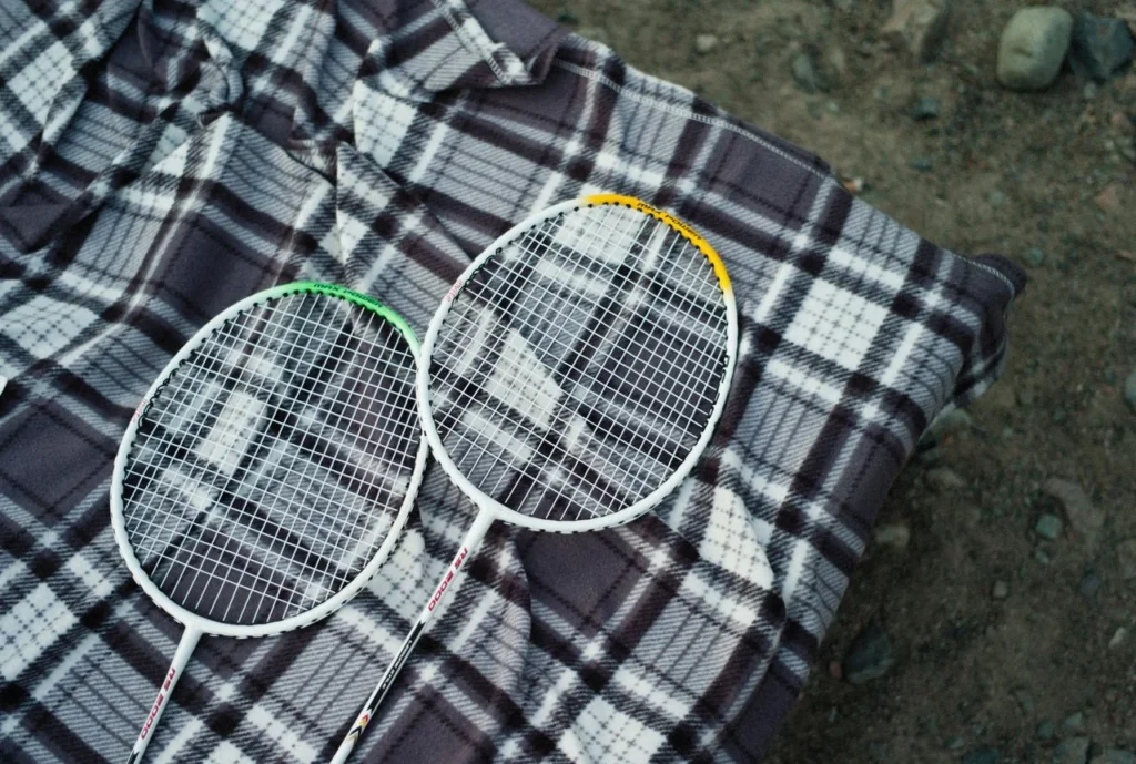 Materials revolutionizing badminton apparel including polyester, recycled polyester, mesh, spandex, nylon, and sustainable badminton uniform fabrics.