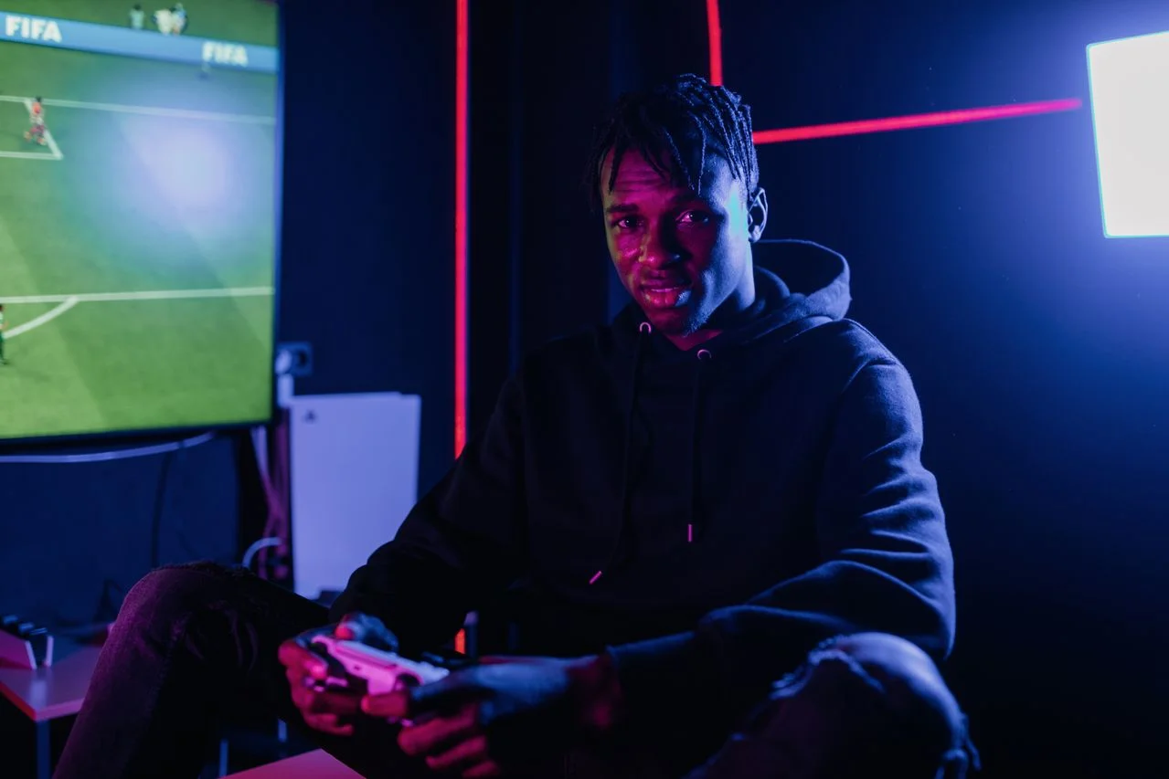 FIFA gaming leagues and football esports players wearing custom esports jerseys in a digital tournament arena.