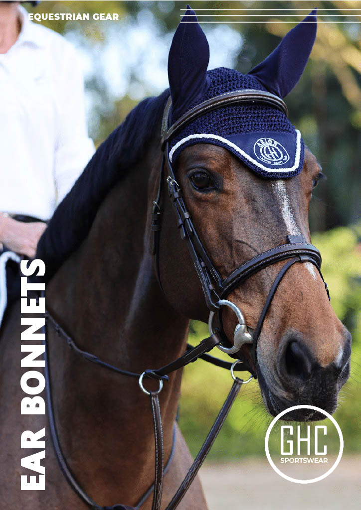 A detailed image of a horse wearing a custom navy blue ear bonnet by GHC Sportswear®, designed for professional equestrian use. The bonnet features breathable crochet fabric with a contrasting trim and embroidered branding. The image text reads “EQUESTRIAN GEAR / EAR BONNETS.” This photo represents custom and OEM equestrian gear production for wholesale distributors, retailers, and importers.