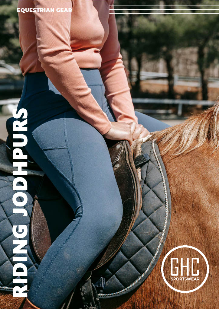 A rider wearing blue stretch riding jodhpurs by GHC Sportswear® while mounted on a horse. The image highlights premium OEM equestrian clothing manufacturing focused on comfort and performance.