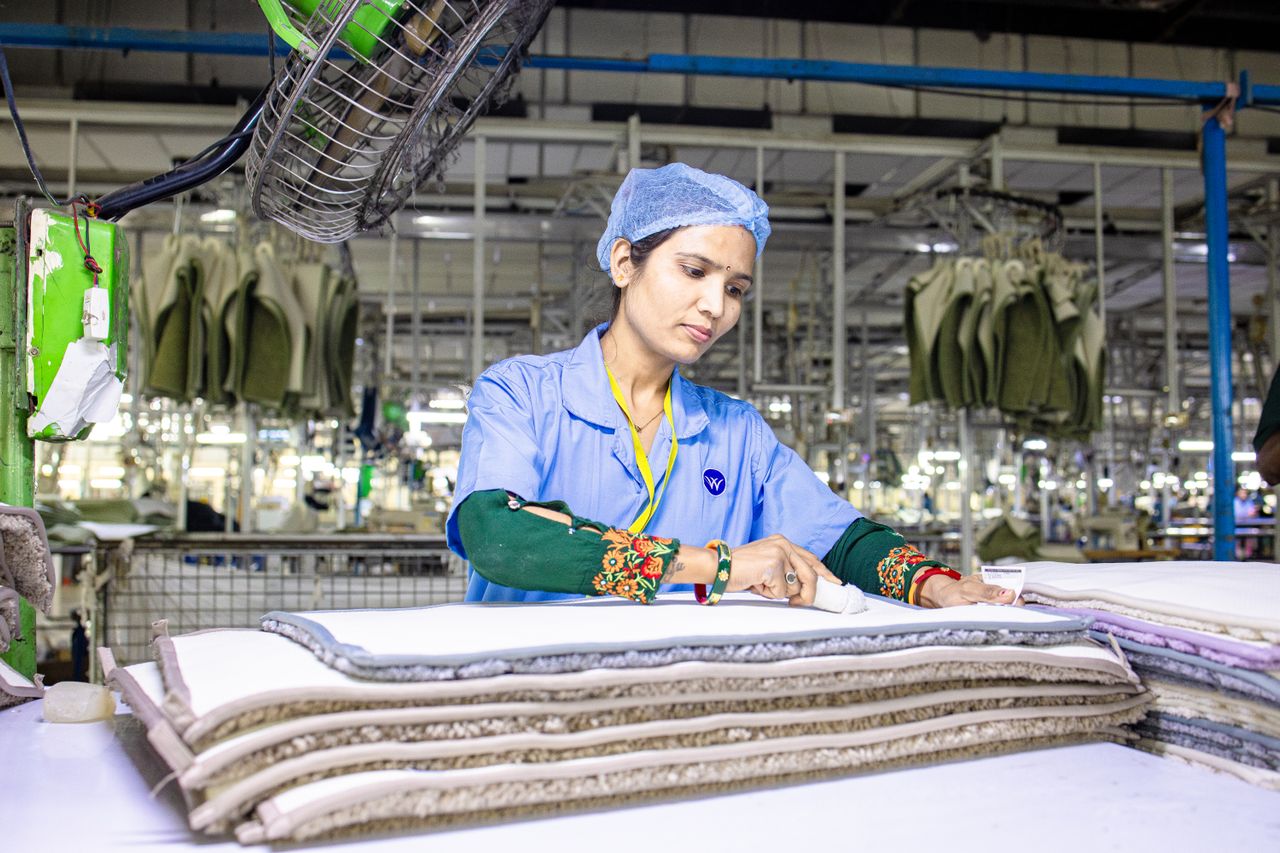 textile worker inspecting fabric during apparel quality control in a garment factory